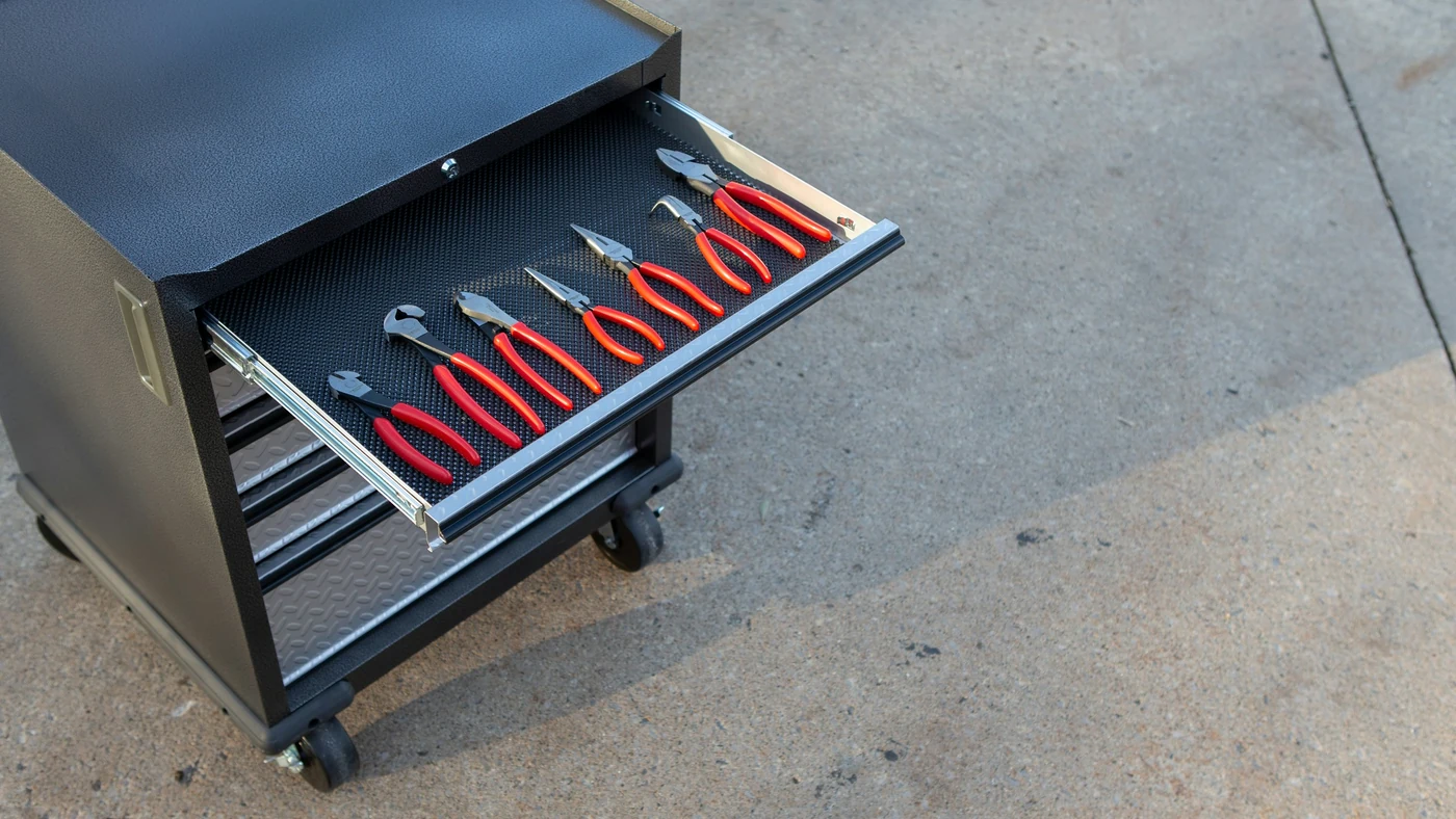 Hand tools arranged in the left side of an organized tool-cabinet drawer
