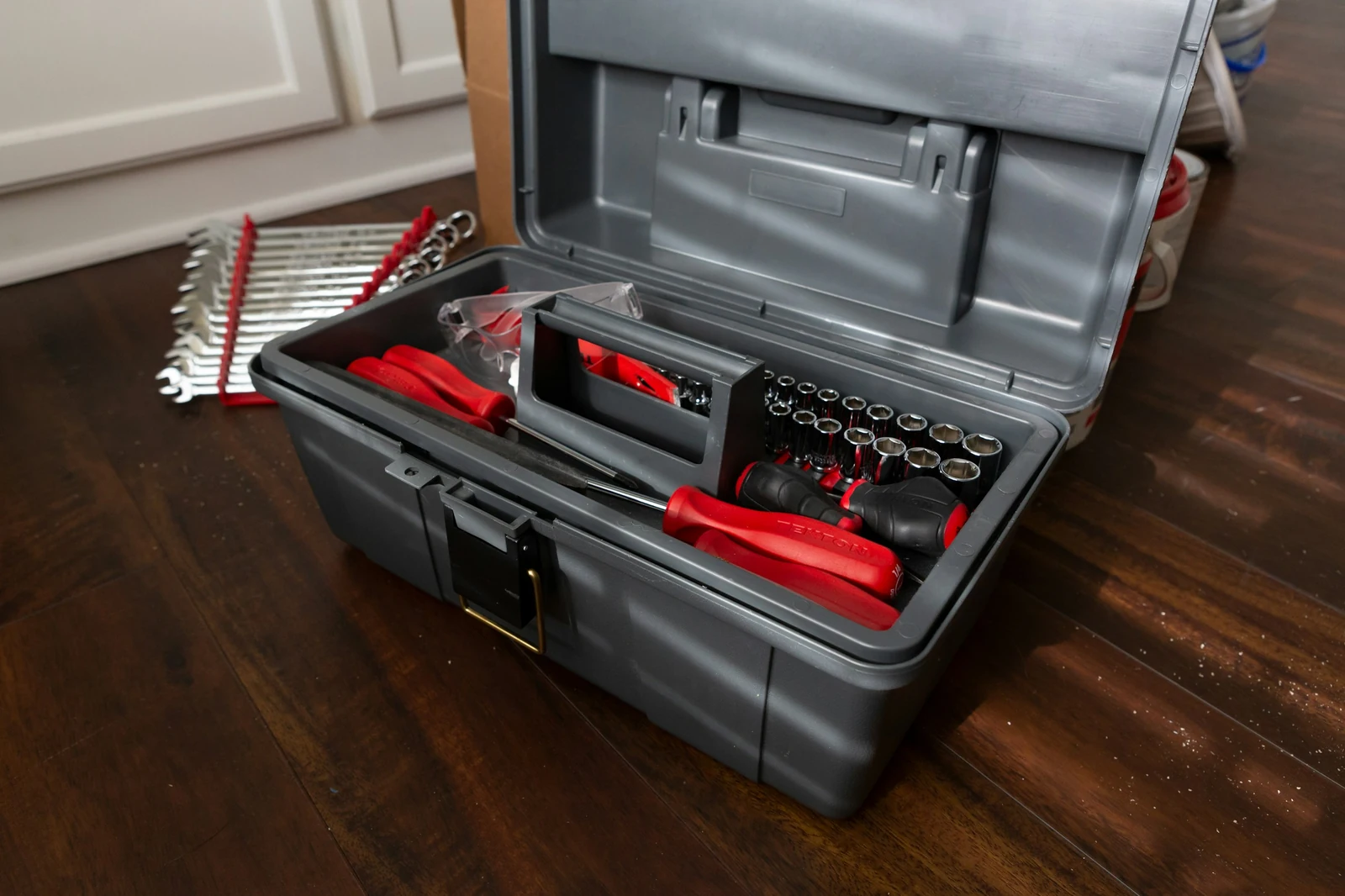 A real assortment of sockets, wrenches and screwdrivers in a tool case