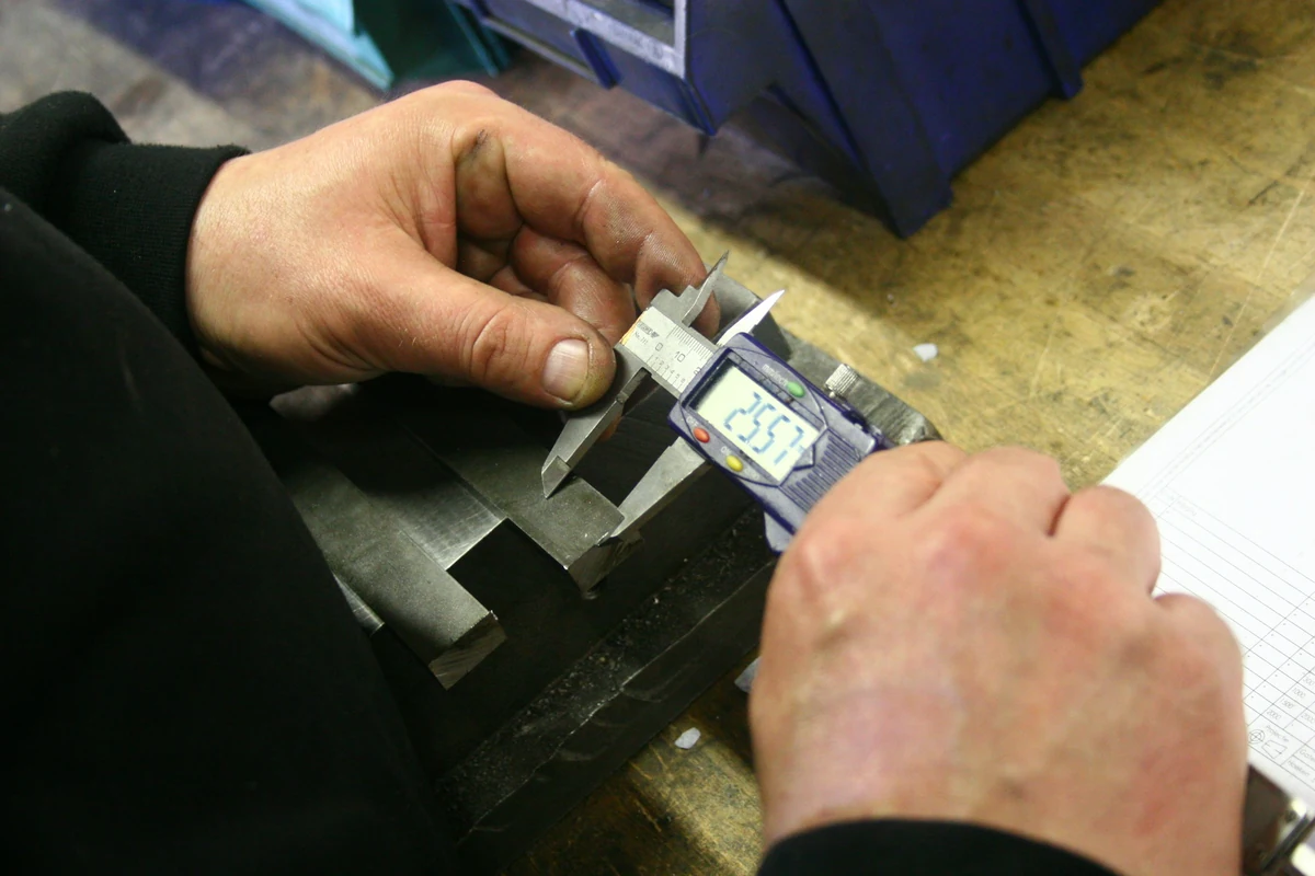 Illustrative digital-caliper measurement of a metal component
